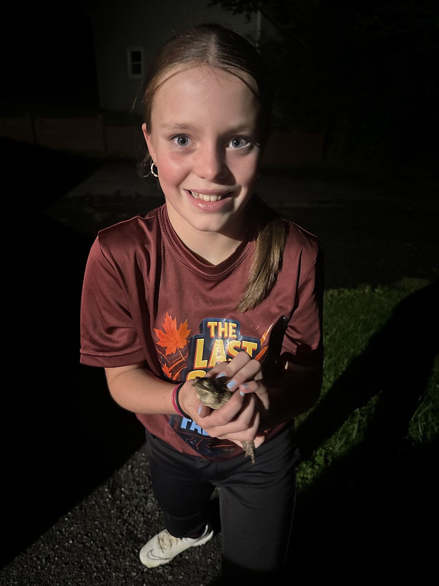 Reese at night holding a toad.
